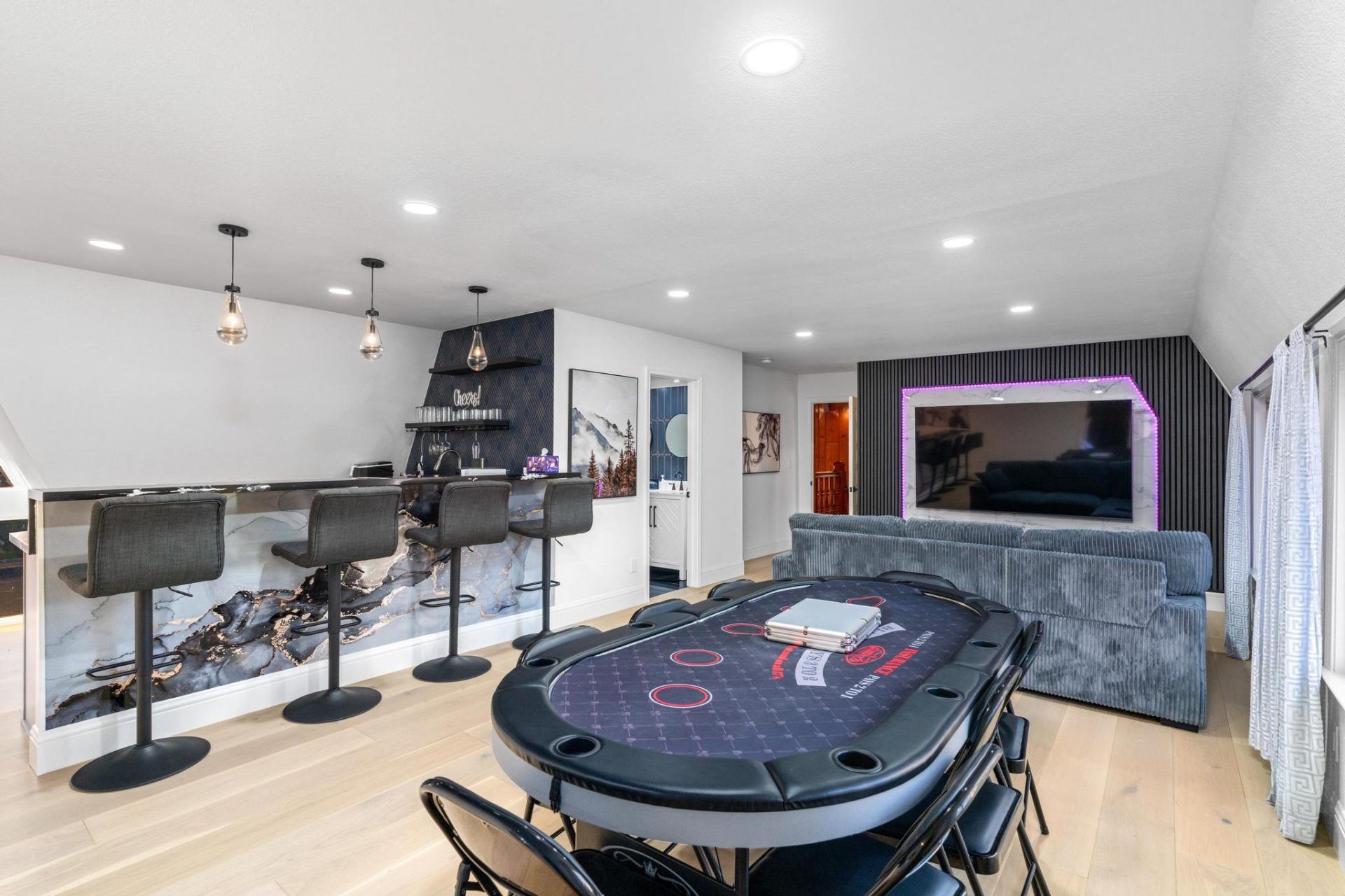 Upstairs entertainment lounge with poker table and wet bar